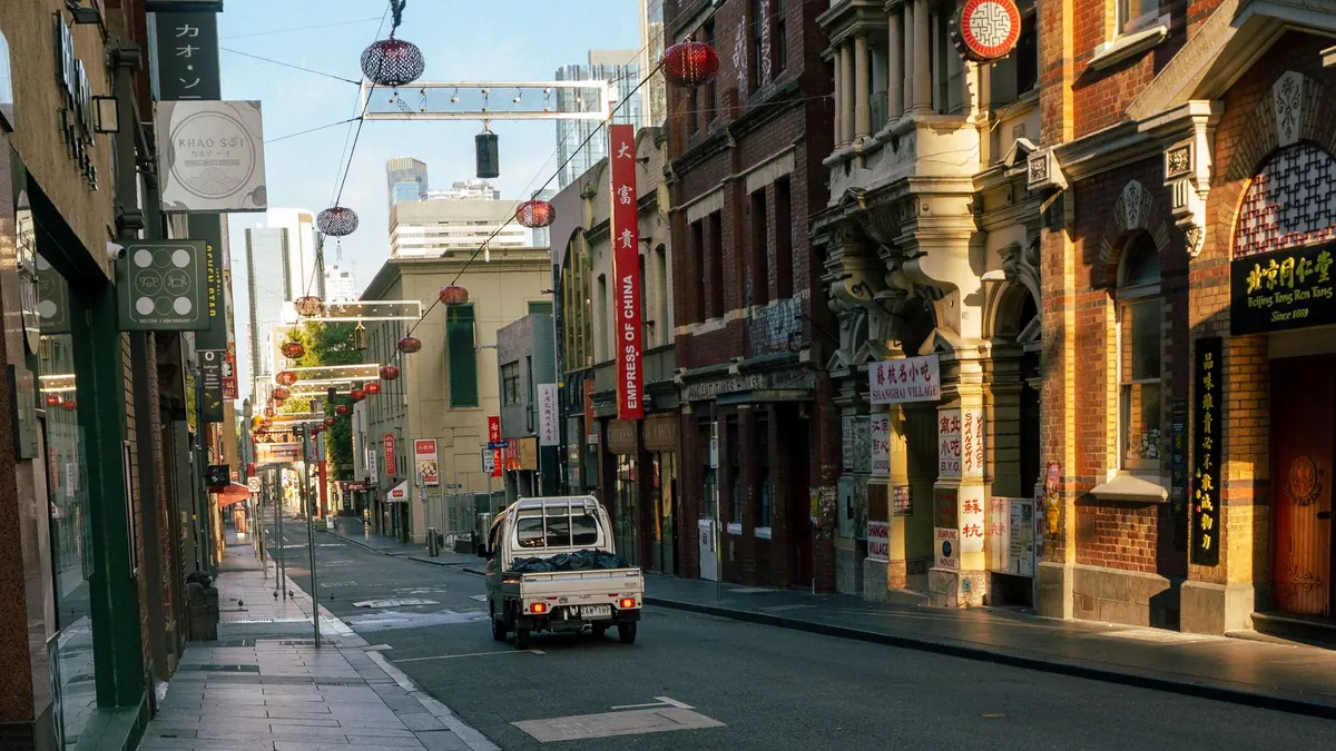 Quiet Melbourne street lined with historic shopfronts in morning light