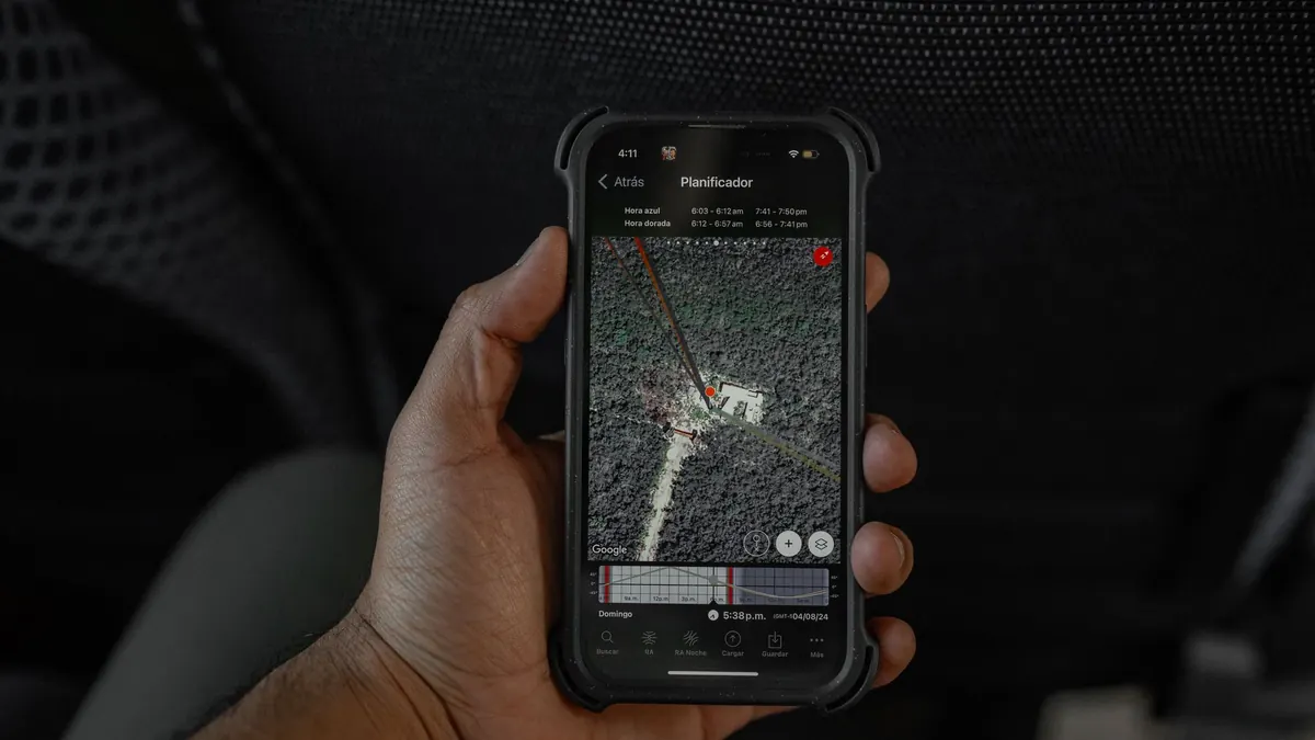 Hand holding a smartphone showing a map on screen