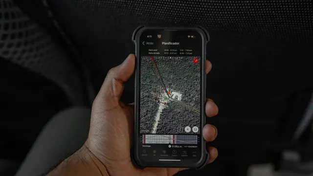 Hand holding a smartphone showing a map on screen
