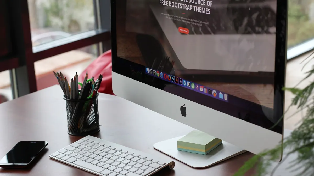 Tidy desk with a desktop computer, keyboard and stationery